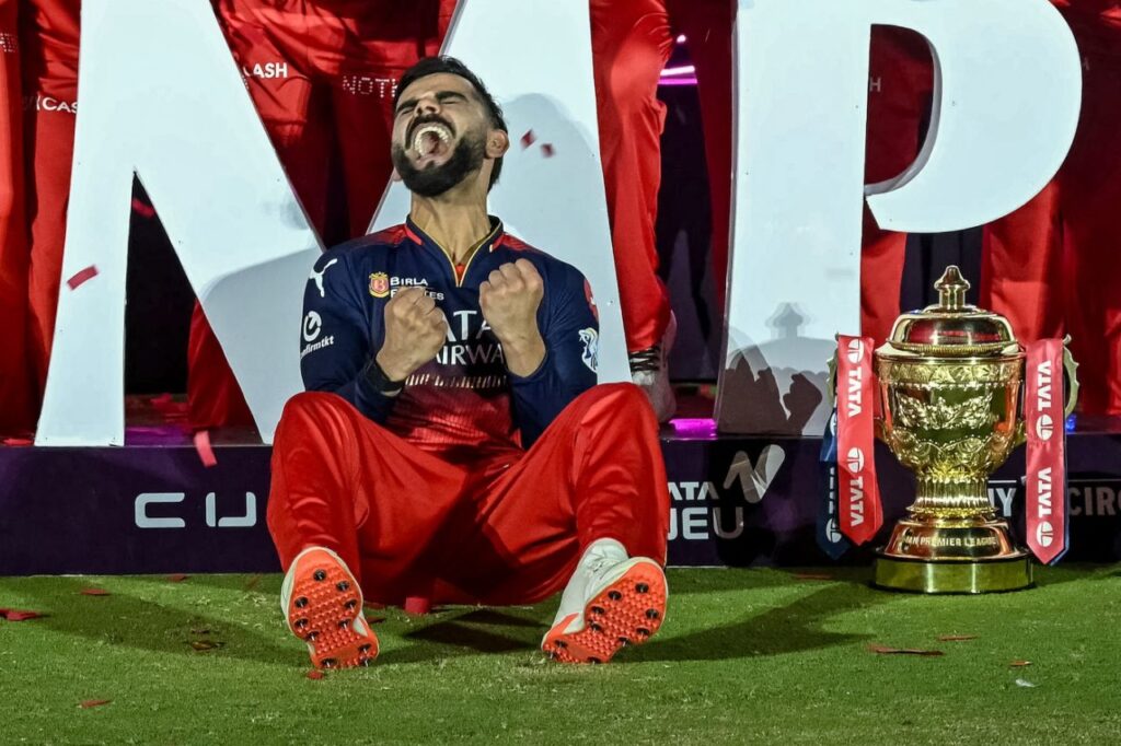 "Virat Kohli, Indian cricket legend, celebrating a century with his trademark aggressive style on the field."